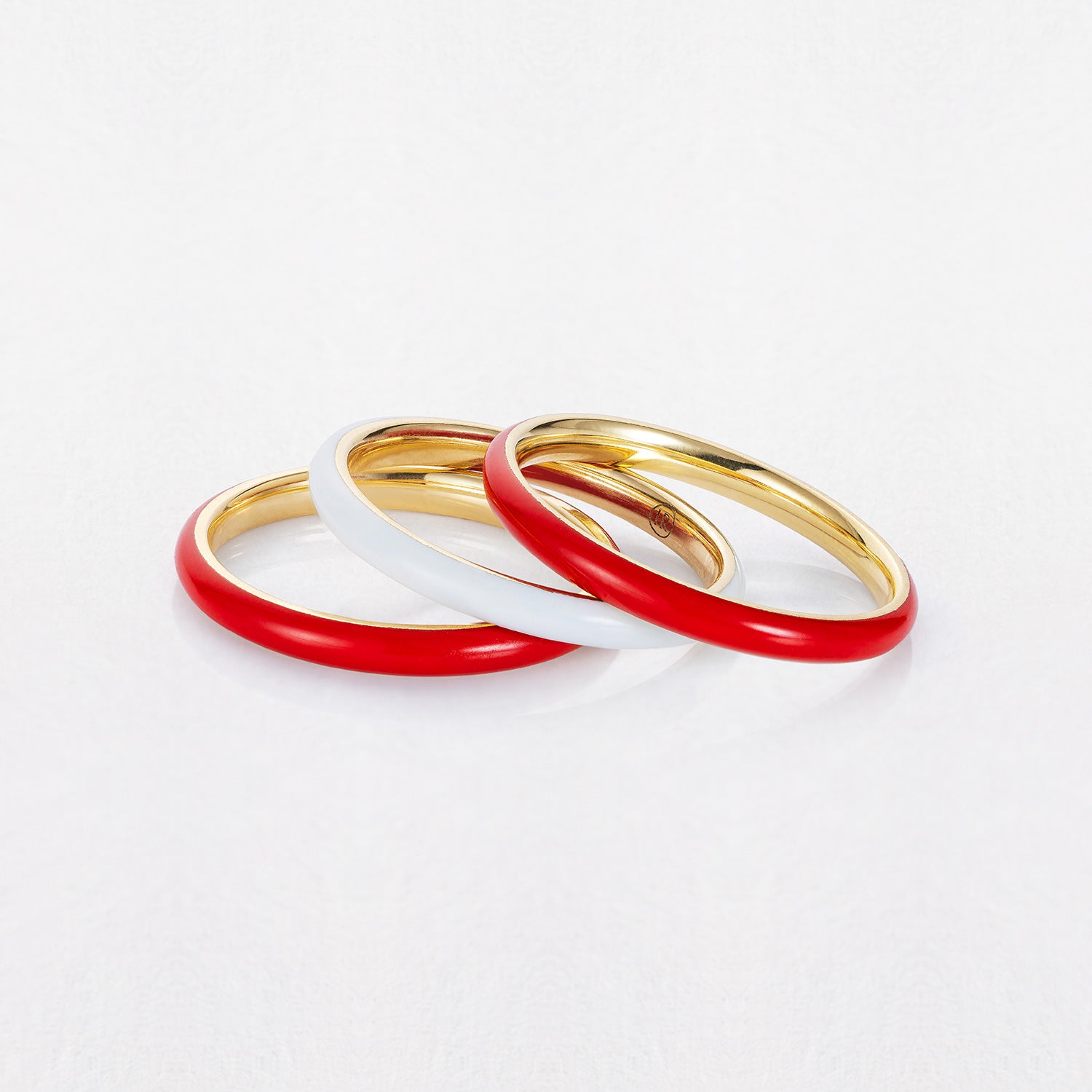 A Red Energy Ring representing the absorption of negative energy and the invitation of good fortune in Buddhist culture. Made in 18K yellow gold with red enamel.