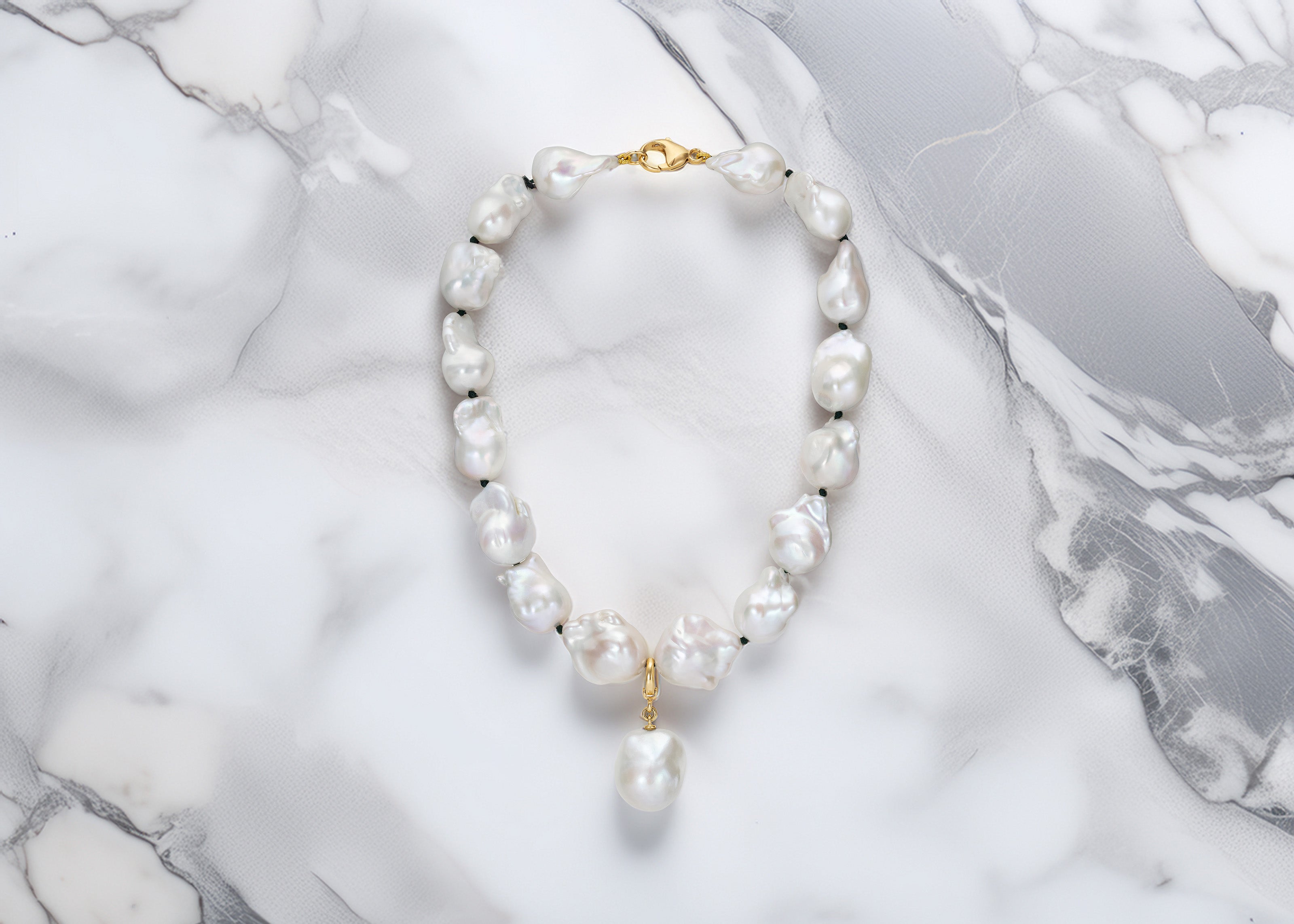 Handcrafted 18K yellow gold Baroque Pearl Necklace featuring unique white baroque freshwater pearls knotted on green thread with pearl drop pendant by Isabella Roux