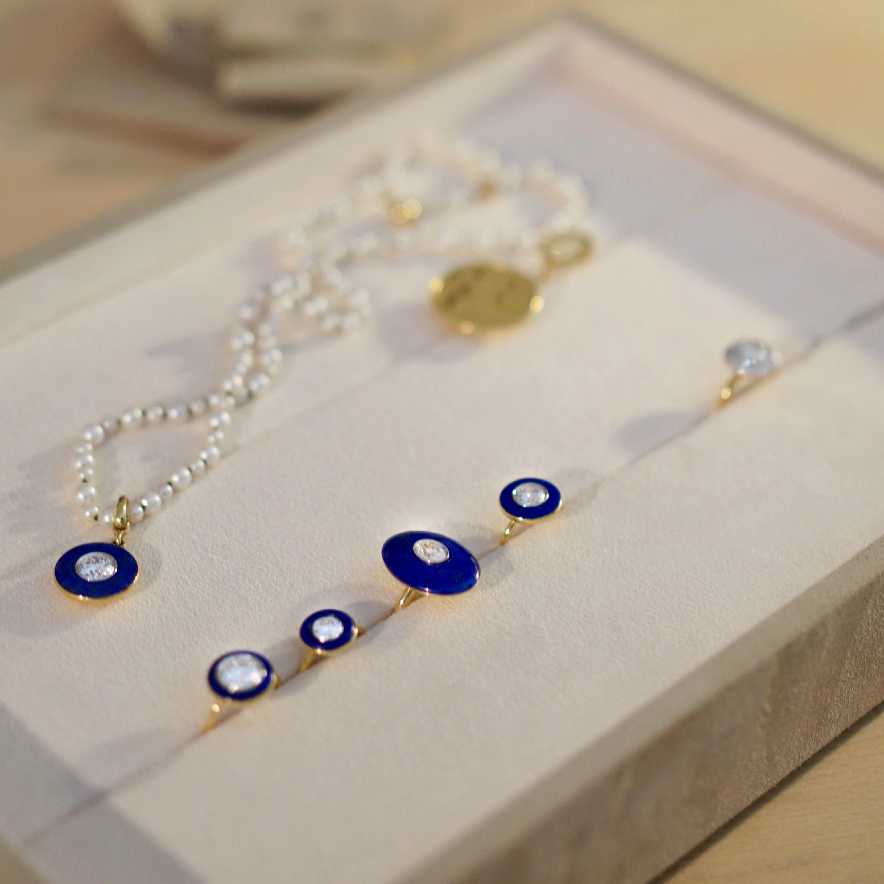 Various handcrafted 18K yellow & white gold Diamond & Lapis Pebble Ring featuring a 0.71ct oval lab grown diamond set inside hand-carved lapis lazuli by Isabella Roux.