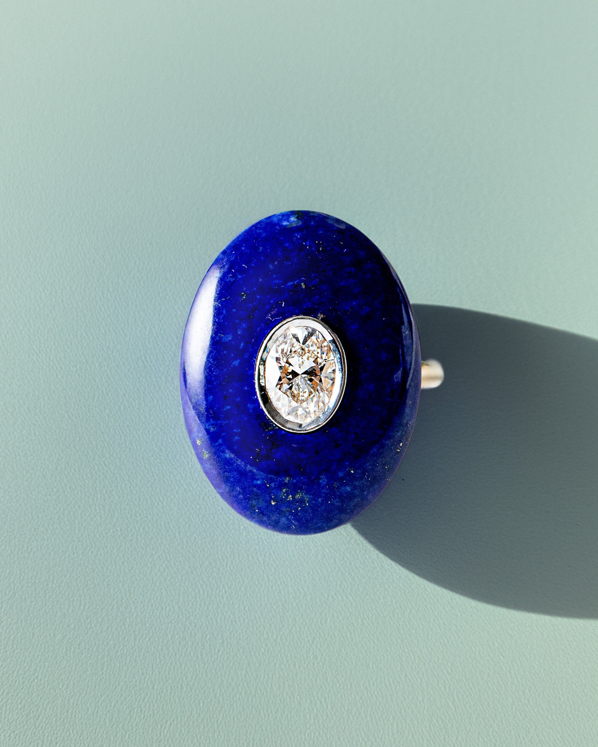Handcrafted 18K yellow & white gold Diamond & Lapis Pebble Ring featuring a 0.71ct oval lab grown diamond set inside hand-carved lapis lazuli by Isabella Roux.