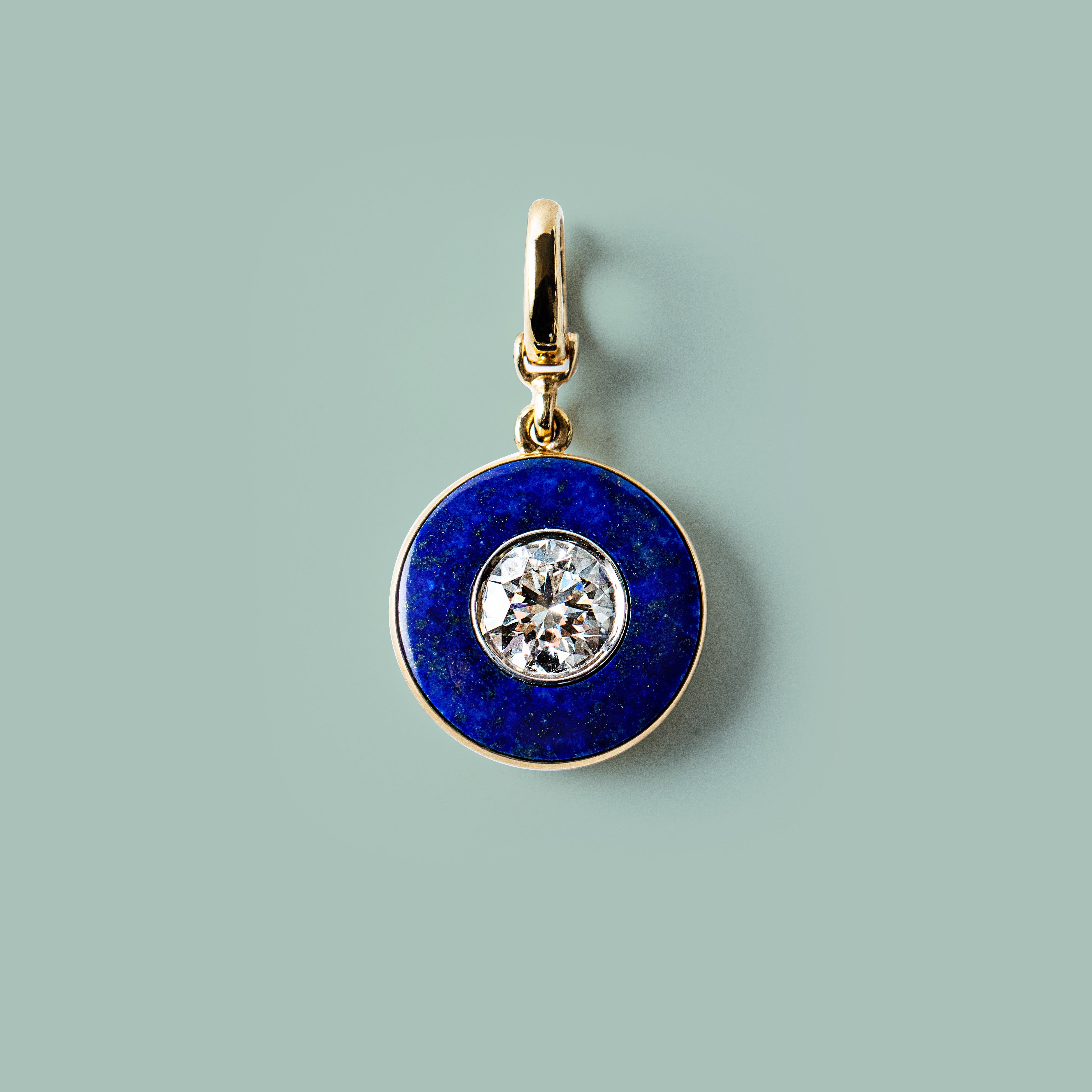 Handcrafted 18K yellow gold Diamond Lapis Charm Pendant featuring a 1.55ct round brilliant lab grown diamond surrounded by a deep blue lapis lazuli inlay with a detachable clasp by Isabella Roux.