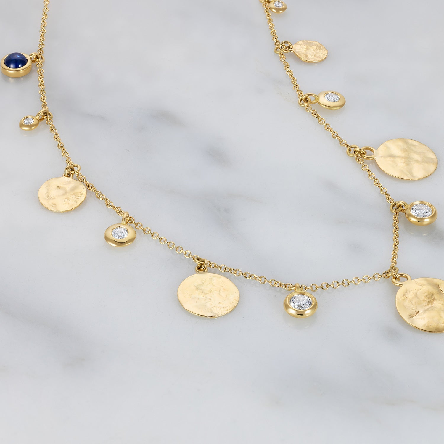 Handcrafted 18K yellow gold Diamond Pebbles & Sun Disk Necklace featuring a mix of beaten sun discs and 1.5 ct diamonds in pebble settings by Isabella Roux