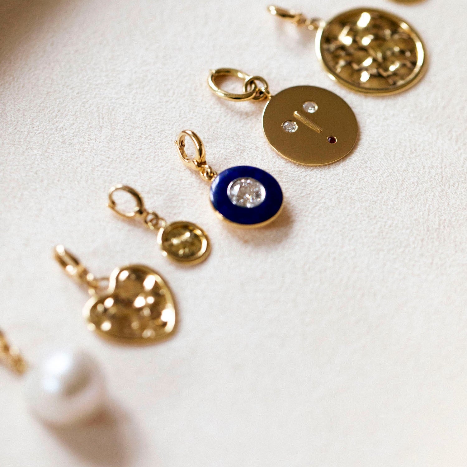 Various 18K yellow gold and diamond charm Pendants by Isabella Roux.