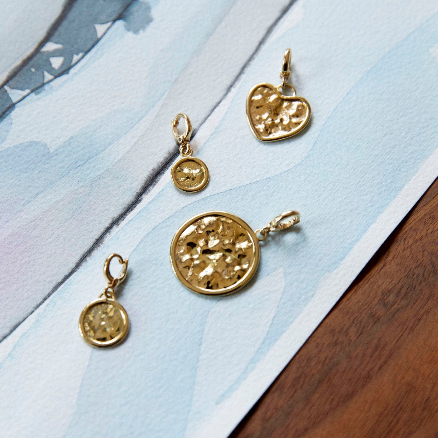 Hand-beaten 18K yellow gold Sun Disc Charm Pendant III featuring a 12mm textured gold disc with a smooth bezel and detachable clasp by Isabella Roux