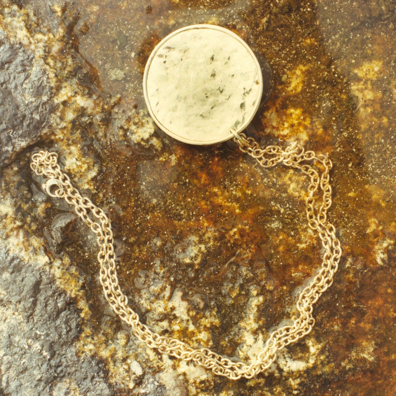 Hand-beaten 18K yellow gold Sun Disc Charm Pendant IV featuring a large 45mm textured gold disc with a smooth bezel and detachable clasp by Isabella Roux