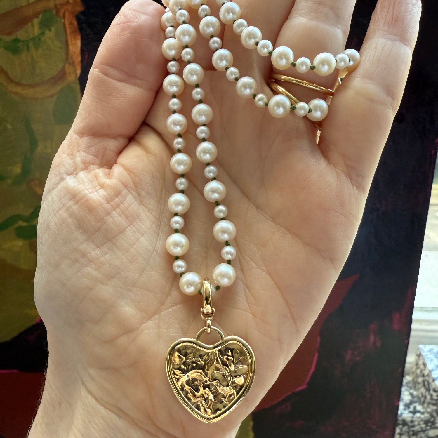 Hand-beaten 18K yellow gold Sun Disc Heart Charm Pendant featuring a 21mm heart-shaped textured gold disc with a smooth bezel and detachable clasp by Isabella Roux