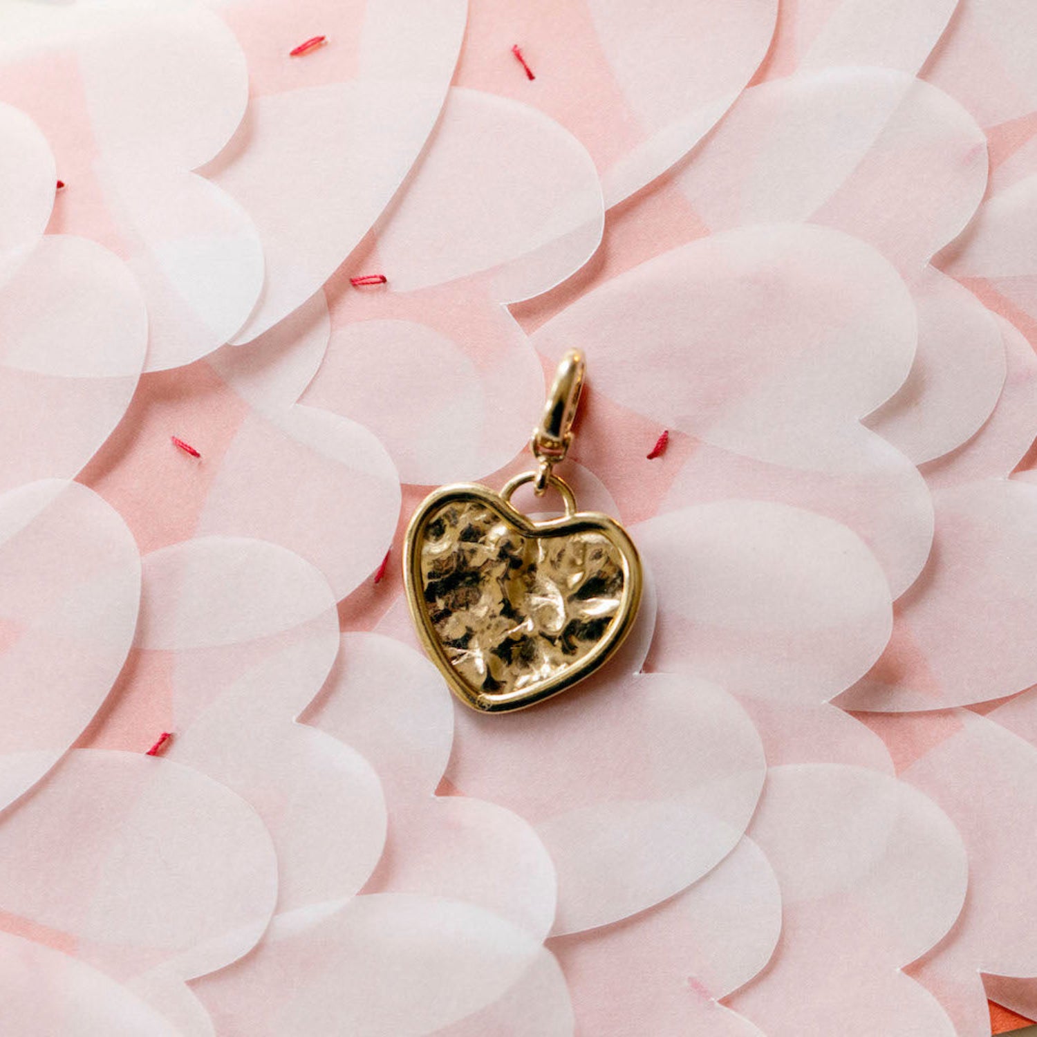 Hand-beaten 18K yellow gold Sun Disc Heart Charm Pendant featuring a 21mm heart-shaped textured gold disc with a smooth bezel and detachable clasp by Isabella Roux