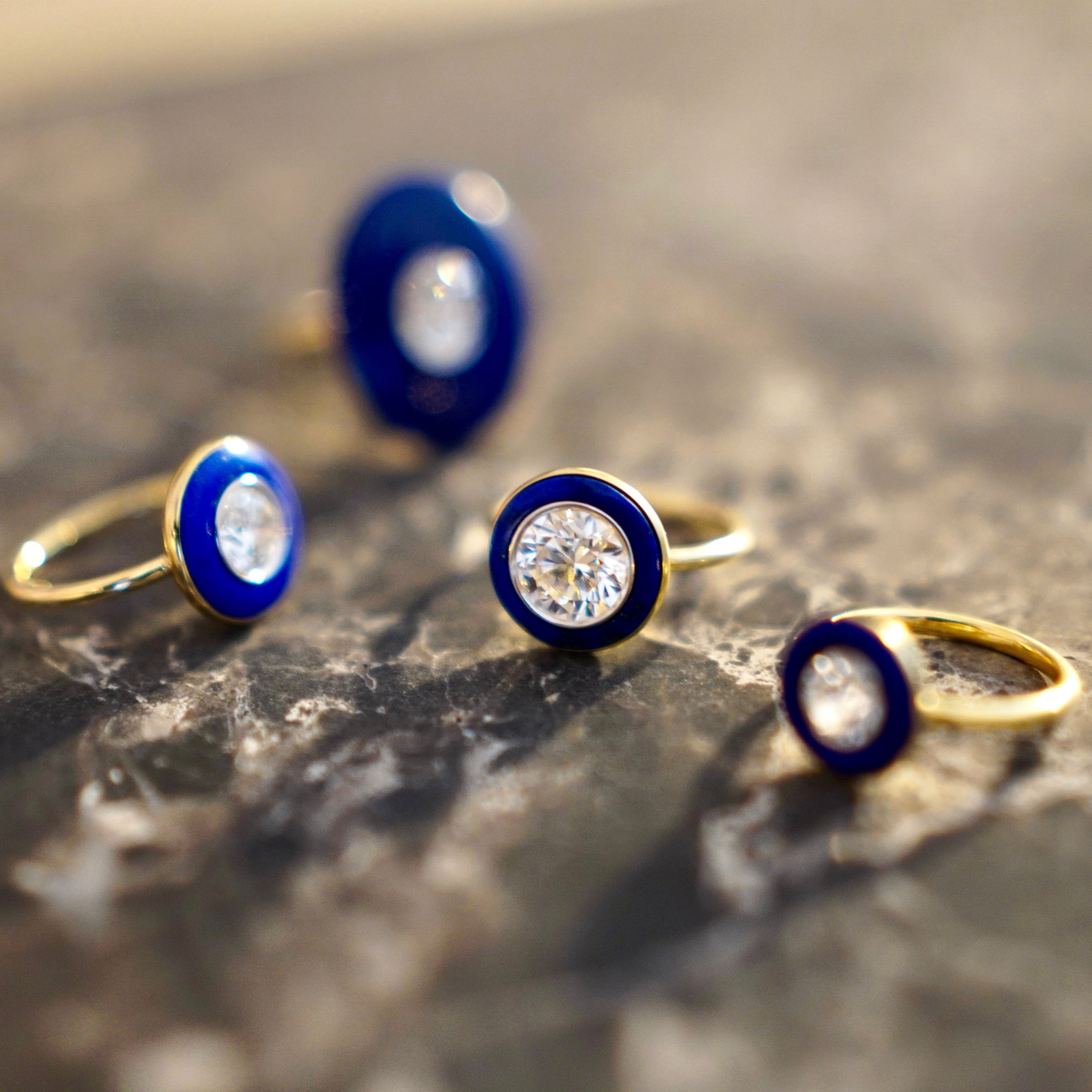 Bespoke 18K yellow & white gold Diamond & Lapis Classic Ring featuring a 2.2ct round brilliant lab grown diamond and carved deep blue lapis lazuli in a halo around by Isabella Roux