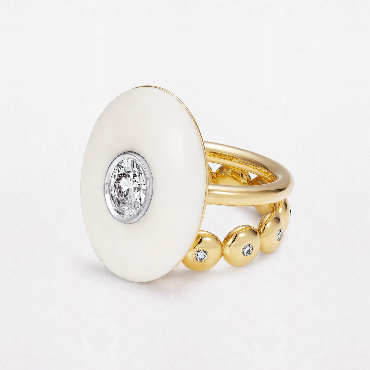 18k gold ring with a carved white opal gemstone and central diamond by Isabella Roux