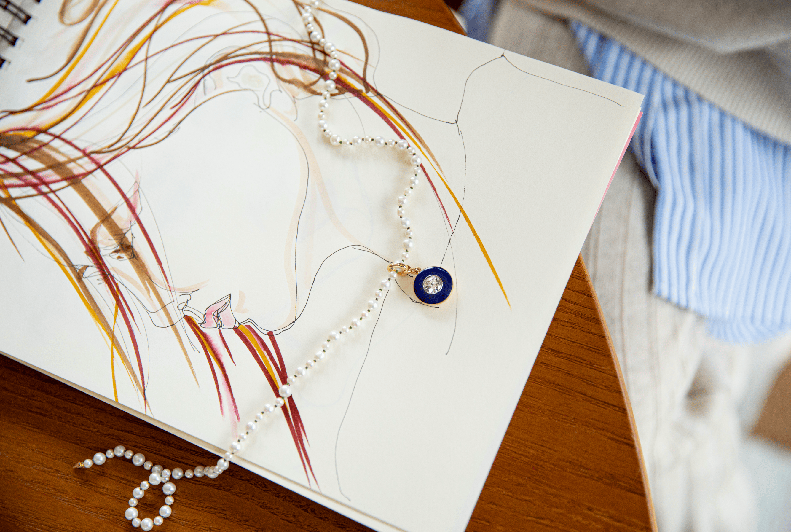 Jewellery design illustration with lapis pendant and pearl necklace by Isabella Roux.
