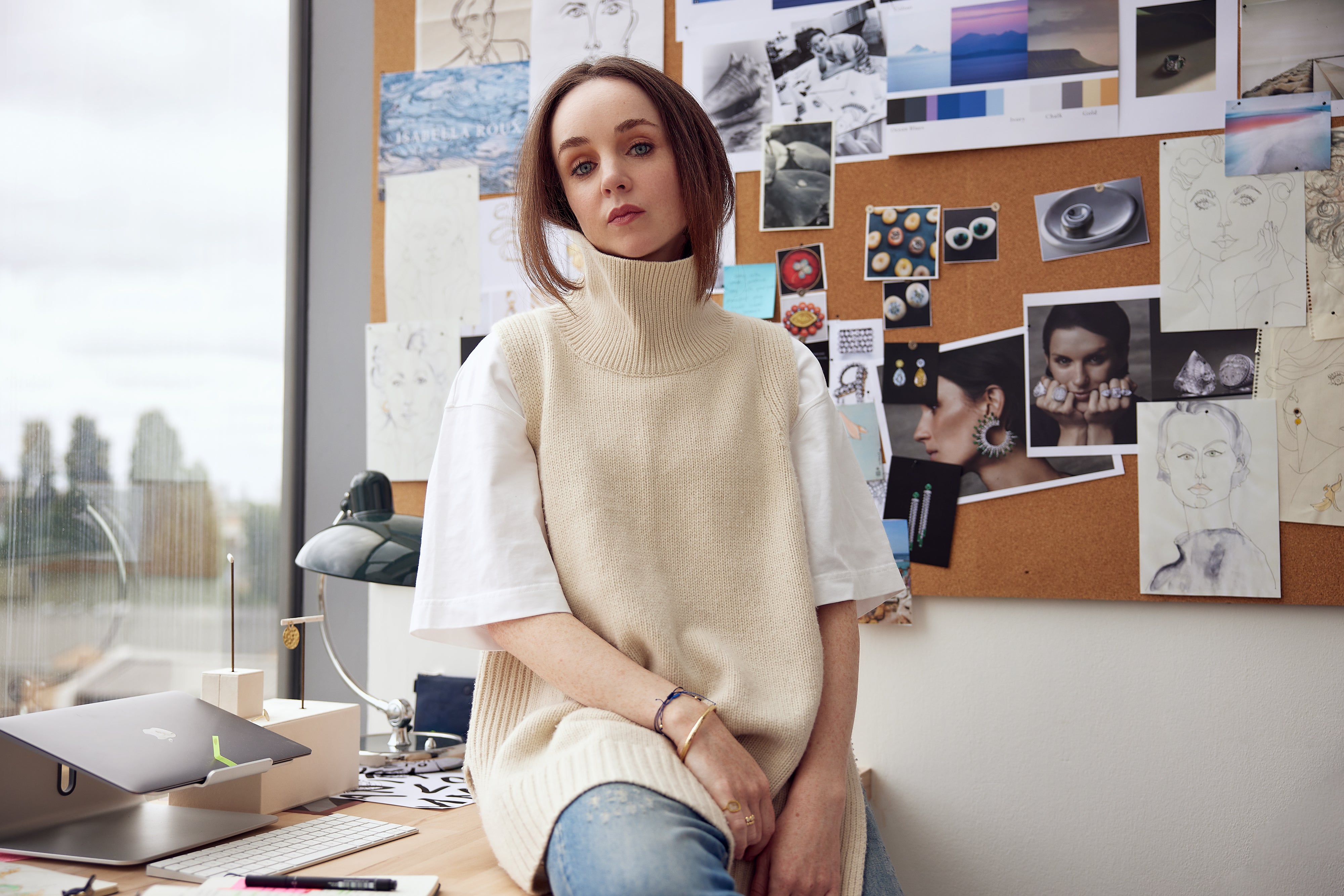 Sadhbh Isabella Roux-Fouillet, Creative Director of Isabella Roux, in her atelier, in front of inspiration board and drawings