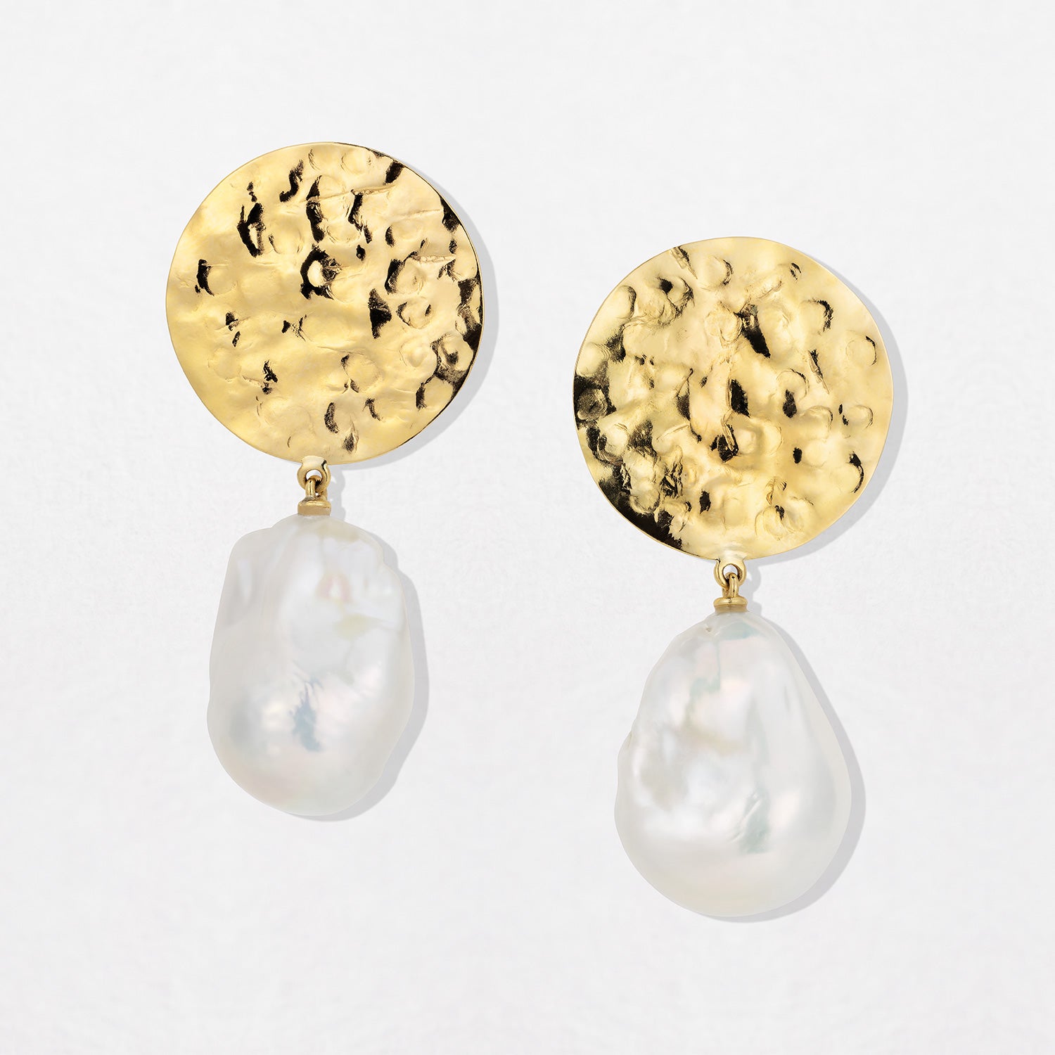 Hand-beaten 18K yellow gold Baroque Pearl Sun Disc Earrings featuring large 25mm textured gold discs and luminous white baroque pearl drops by Isabella Roux