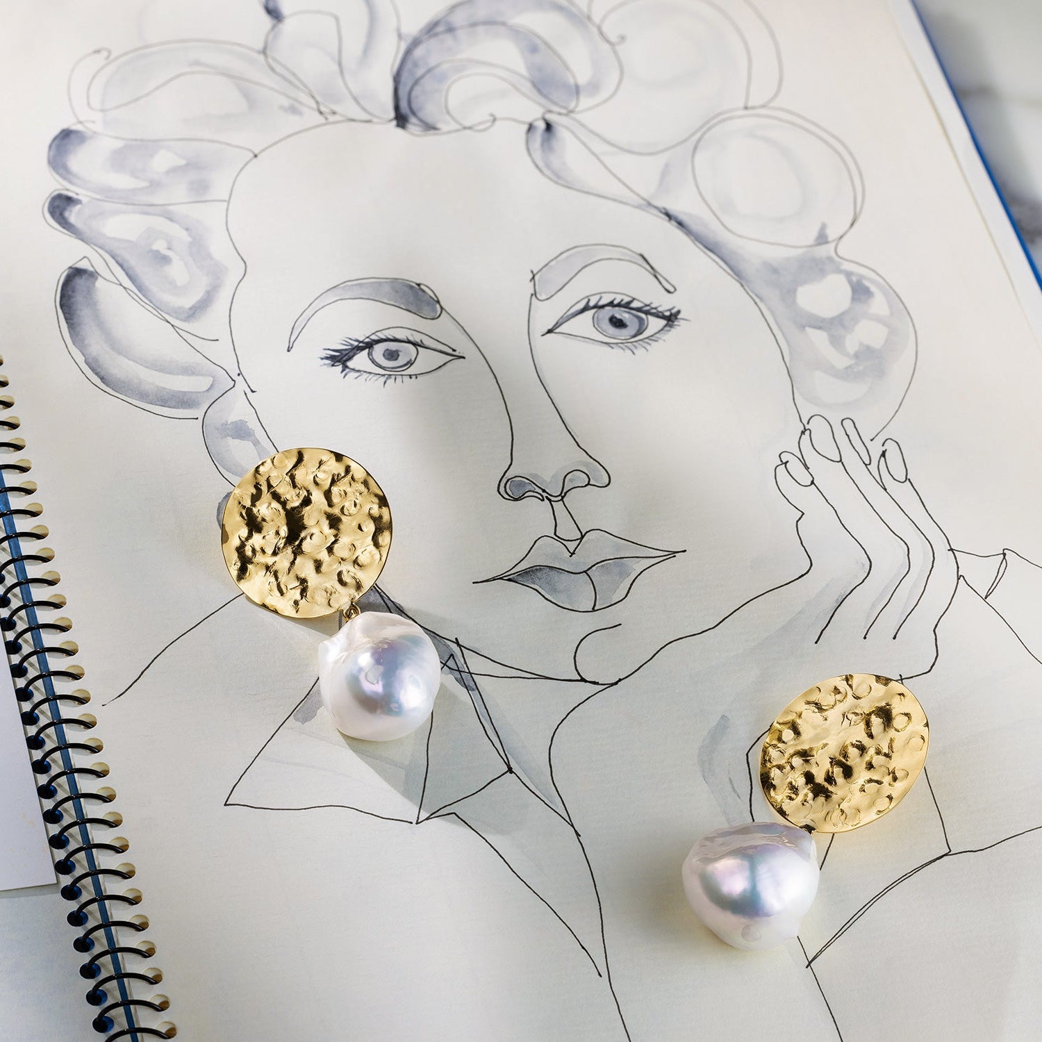 Hand-beaten 18K yellow gold Baroque Pearl Sun Disc Earrings featuring large 25mm textured gold discs and luminous white baroque pearl drops by Isabella Roux