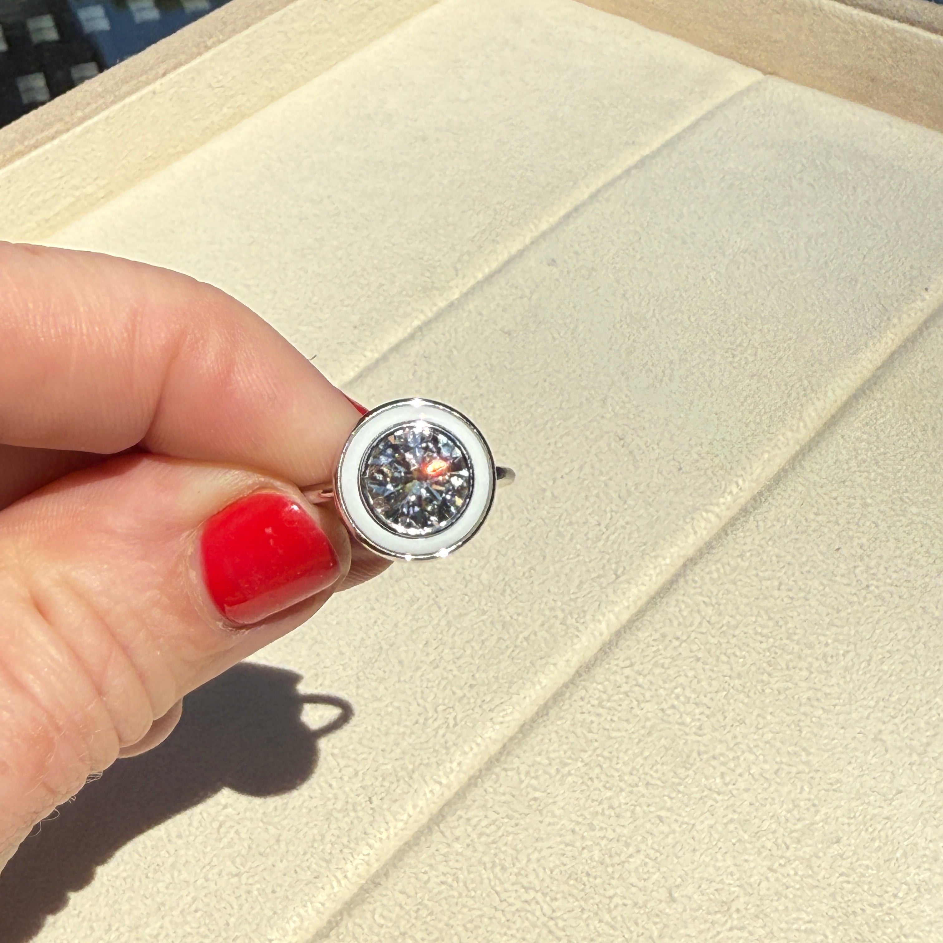 Hand holding a bespoke 18K white gold Bespoke Classic Ring featuring a customisable 2ct round brilliant lab grown diamond and coloured hardstone of choice surround by Isabella Roux.