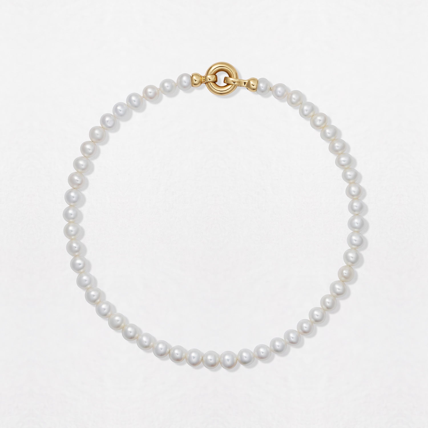 Handcrafted Classic Pearl Choker Necklace featuring 7mm white freshwater pearls strung with an 18K yellow gold clasp at a 15" length by Isabella Roux
