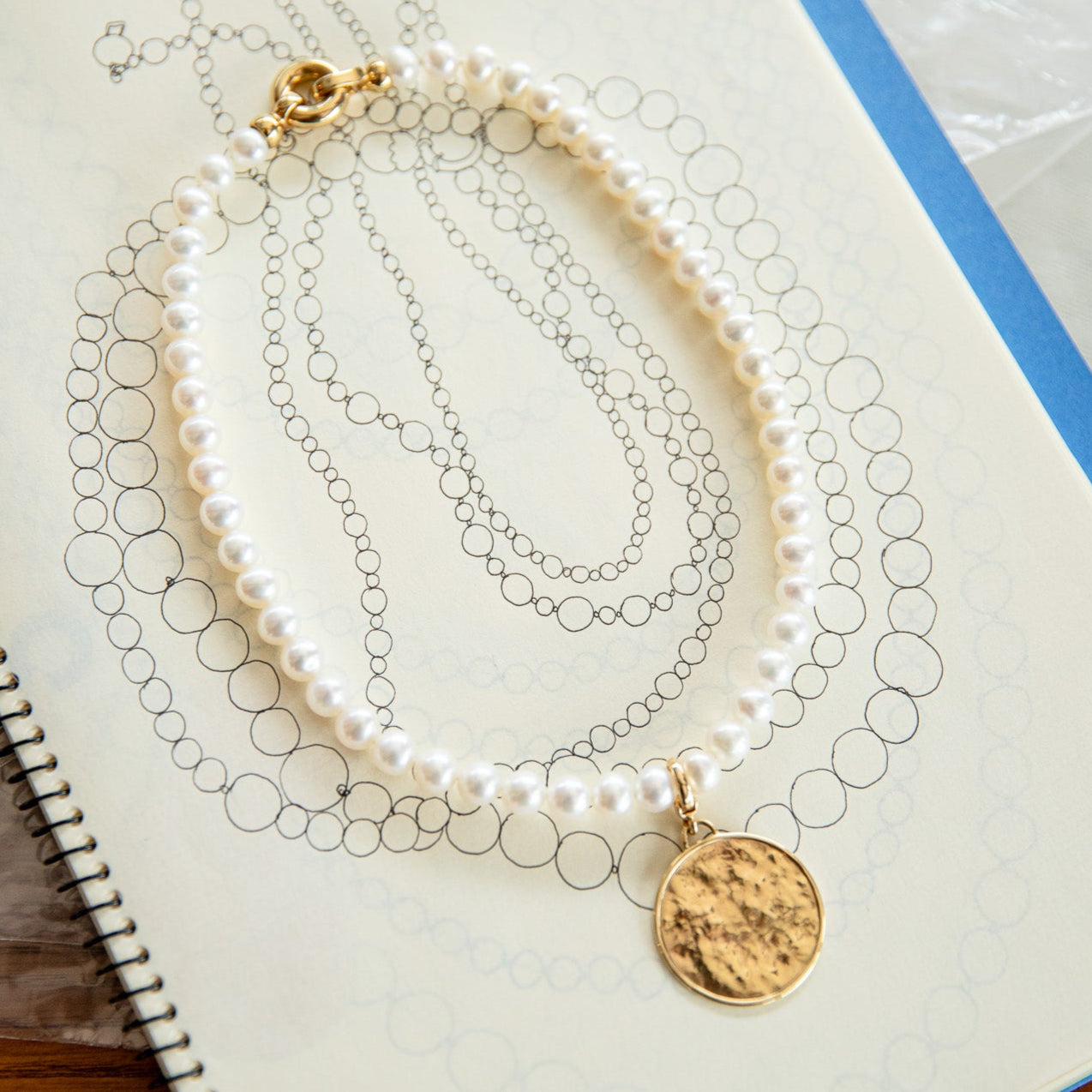 Handcrafted Classic Pearl Choker Necklace featuring 7mm white freshwater pearls strung with an 18K yellow gold clasp at a 15" length by Isabella Roux