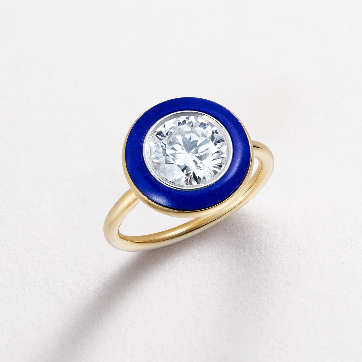 Bespoke 18K yellow & white gold Diamond & Lapis Classic Ring featuring a 2.2ct round brilliant lab grown diamond and carved deep blue lapis lazuli in a halo around by Isabella Roux