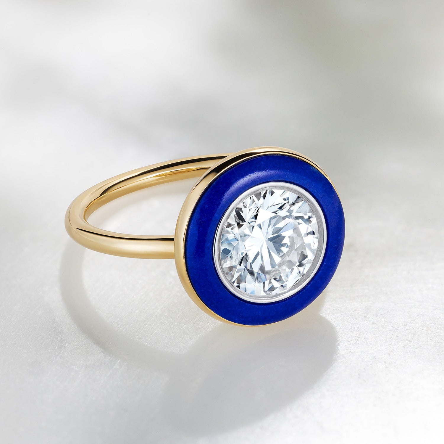 Bespoke 18K yellow & white gold Diamond & Lapis Classic Ring featuring a 2.2ct round brilliant lab grown diamond and carved deep blue lapis lazuli in a halo around by Isabella Roux