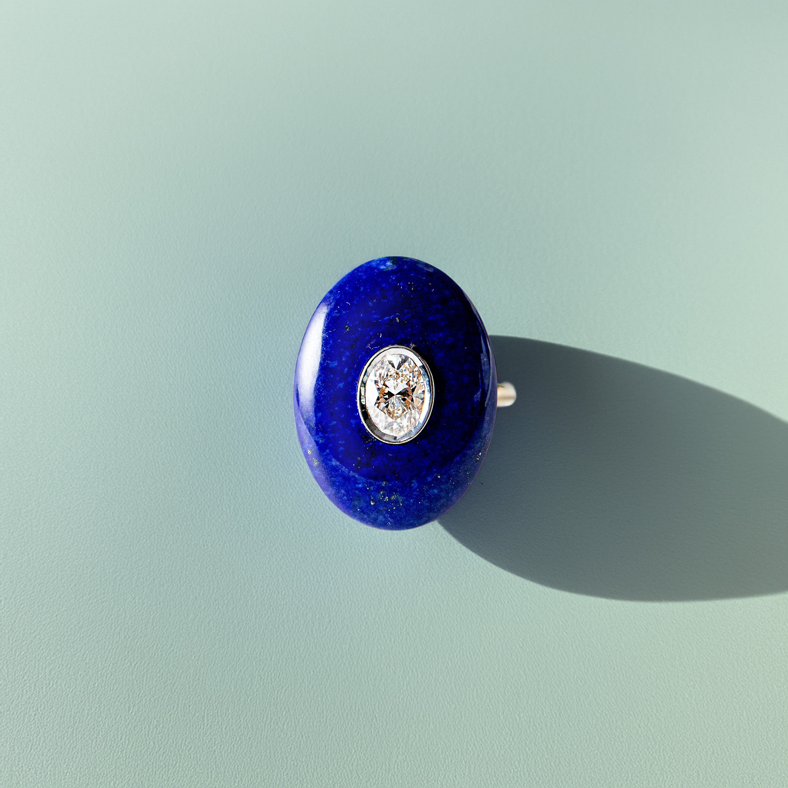 Hand-carved 18K yellow & white gold Diamond & Lapis Pebble Ring featuring a 0.71ct oval lab grown diamond set inside hand-carved lapis lazuli by Isabella Roux.