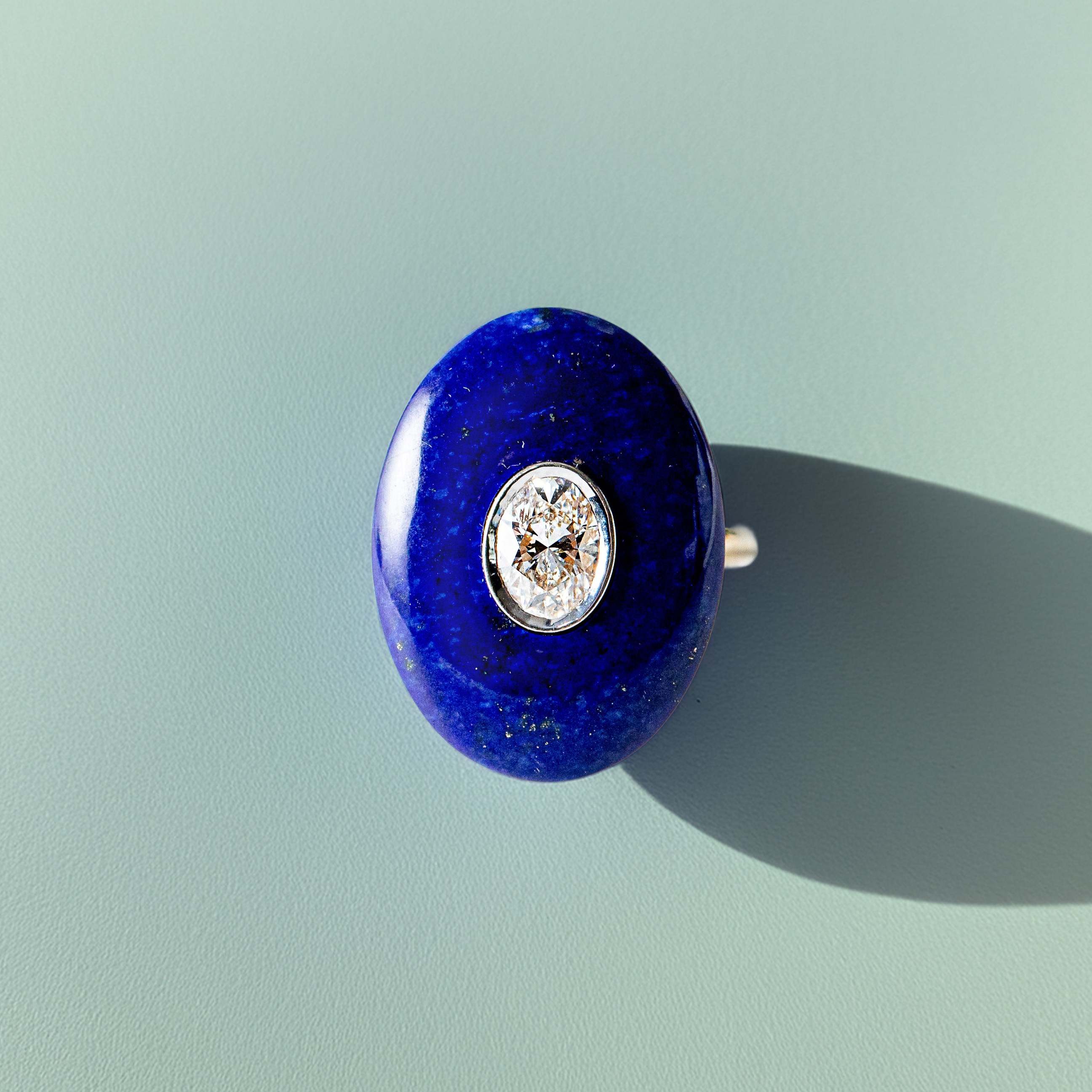 Handcrafted 18K yellow & white gold Diamond & Lapis Pebble Ring featuring a 0.71ct oval lab grown diamond set inside hand-carved lapis lazuli by Isabella Roux.