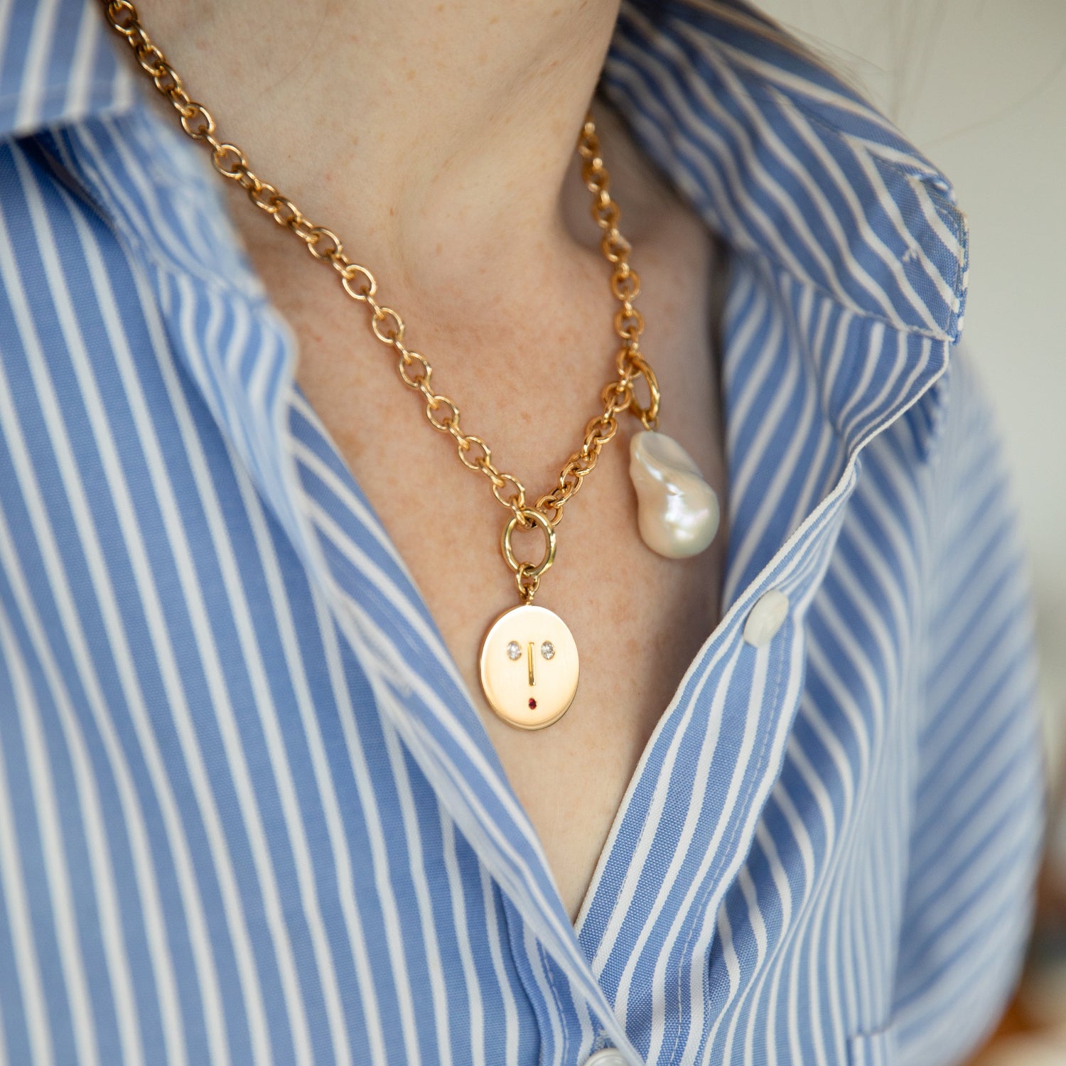 Gold necklace with 18K yellow gold Diamond & Ruby Face Charm Pendant featuring a stylized face set with sparkling diamond eyes and ruby mouth by Isabella Roux.