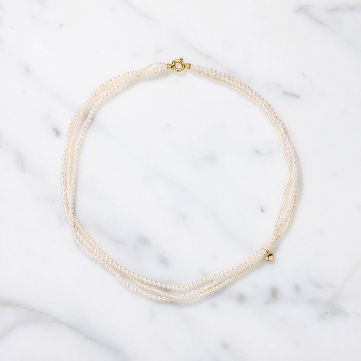 Handcrafted 18K yellow gold Akoya Pebble Seed Pearl Twist Collar Necklace featuring delicate seed pearls and a gold clasp by Isabella Roux