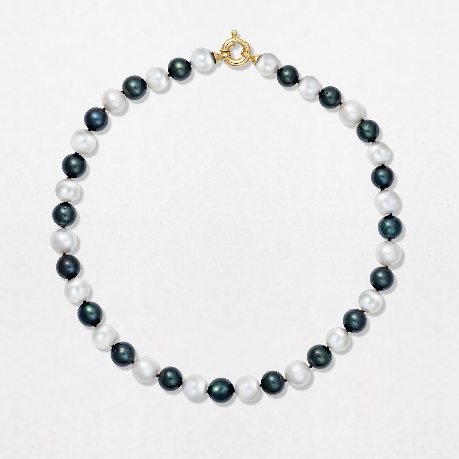 Handcrafted Pebble Monochrome Necklace featuring a set of black and white freshwater pearls knotted on navy thread with 18K yellow gold fittings by Isabella Roux