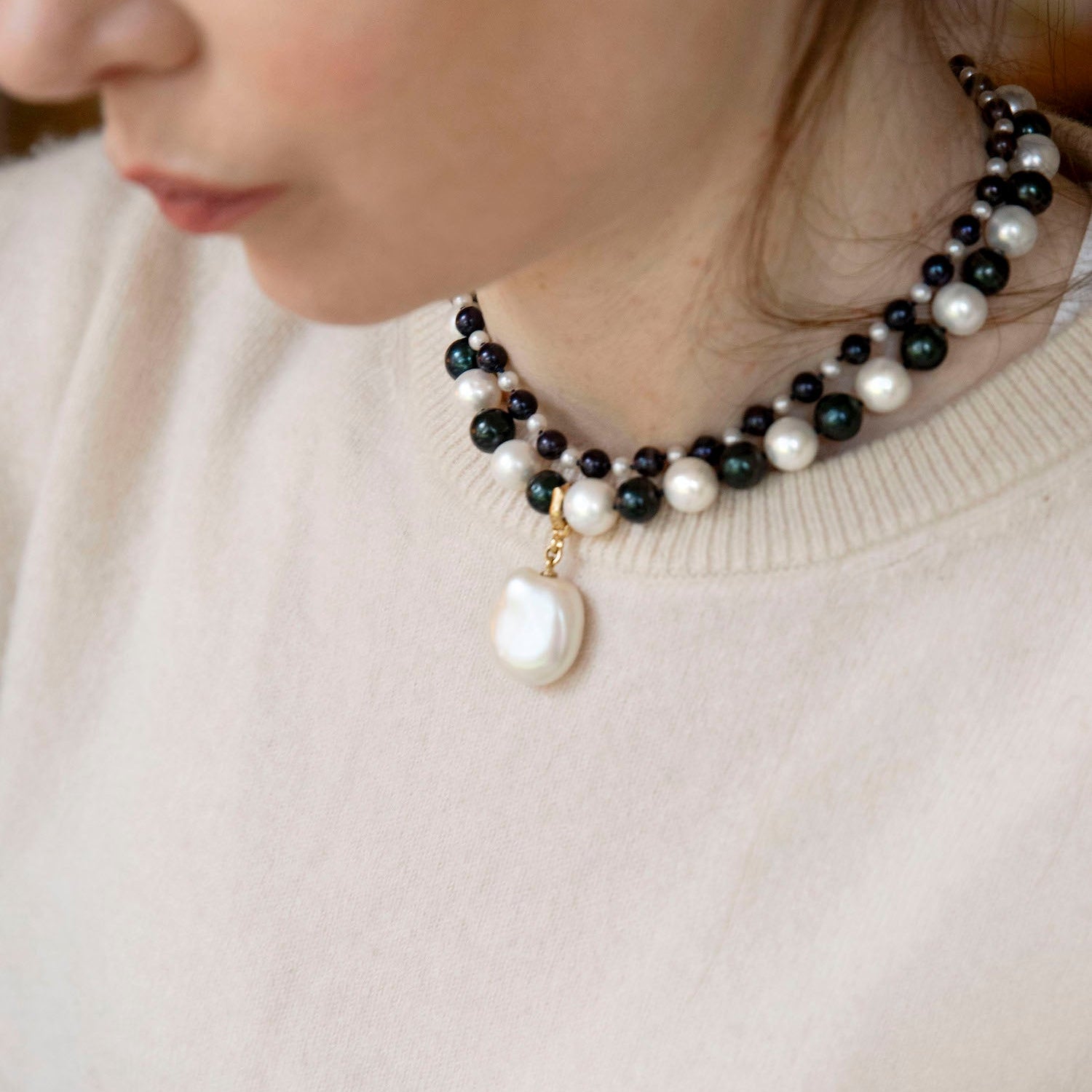 Handcrafted Pebble Monochrome Necklace featuring a set of black and white freshwater pearls knotted on navy thread with 18K yellow gold fittings by Isabella Roux