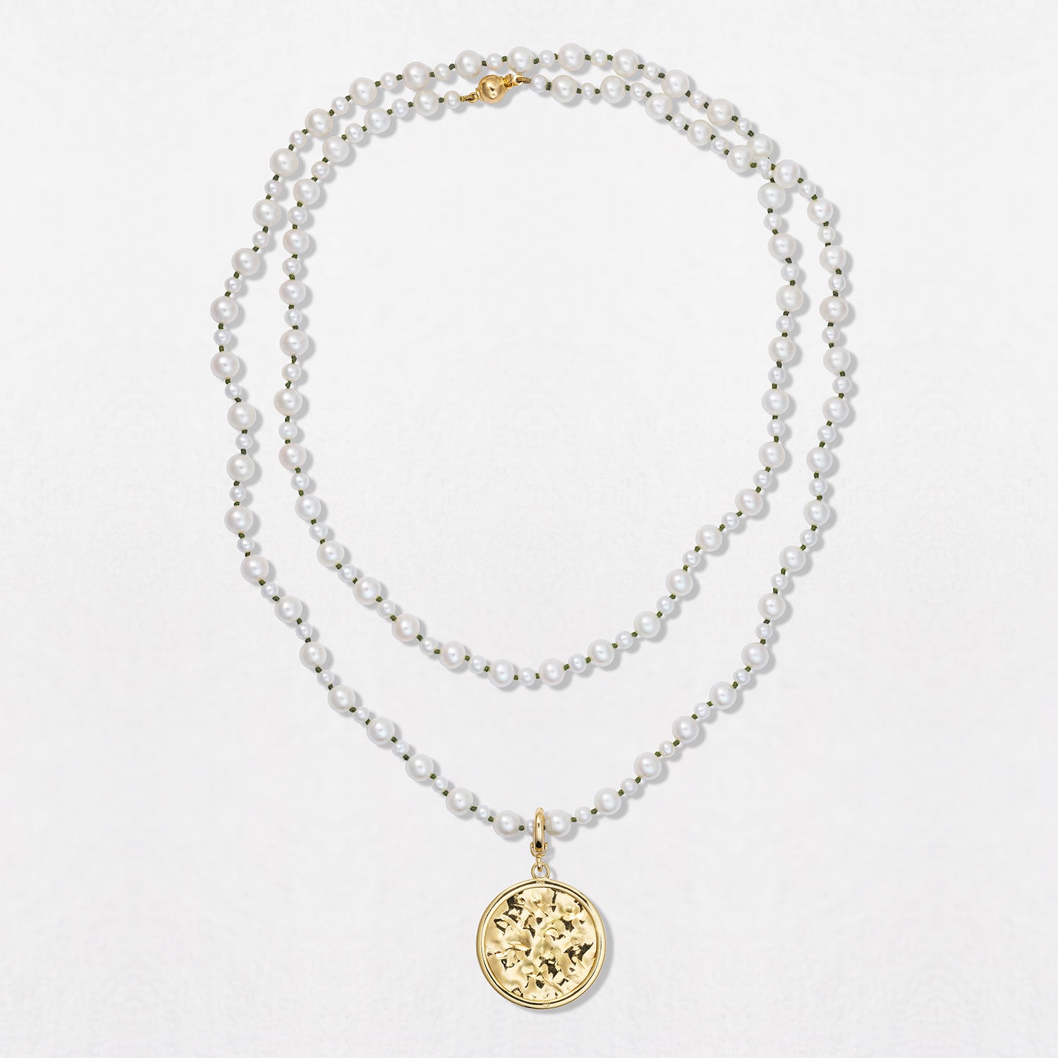 Handcrafted Pebble Pearl 32" Necklace featuring a long strand of round freshwater pearls and 18K yellow gold clasp and beaten gold pendant by Isabella Roux.