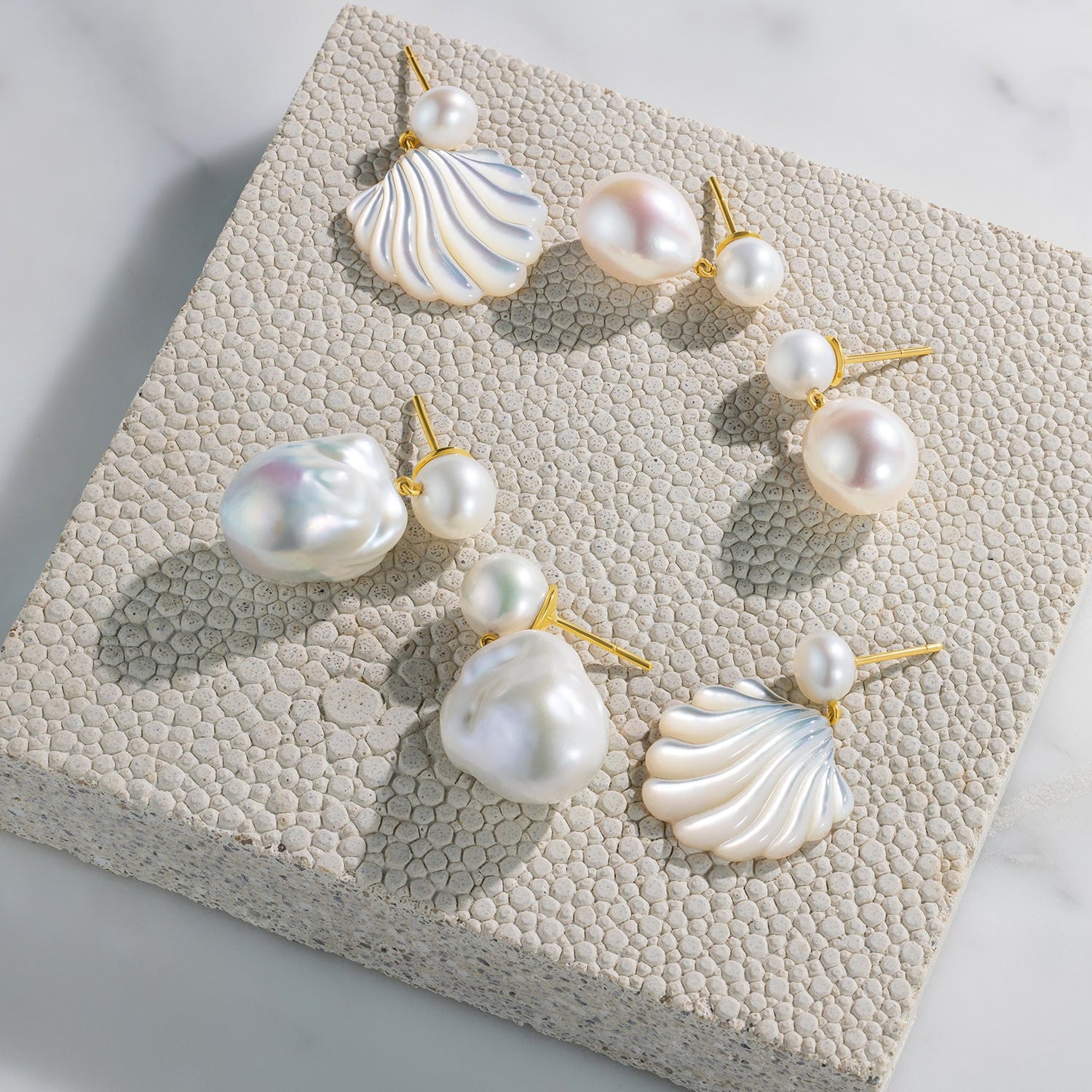 Hand-carved 18K yellow gold Shell Pearl Earrings featuring 20mm hand-carved mother of pearl shells and freshwater white pearls by Isabella Roux.