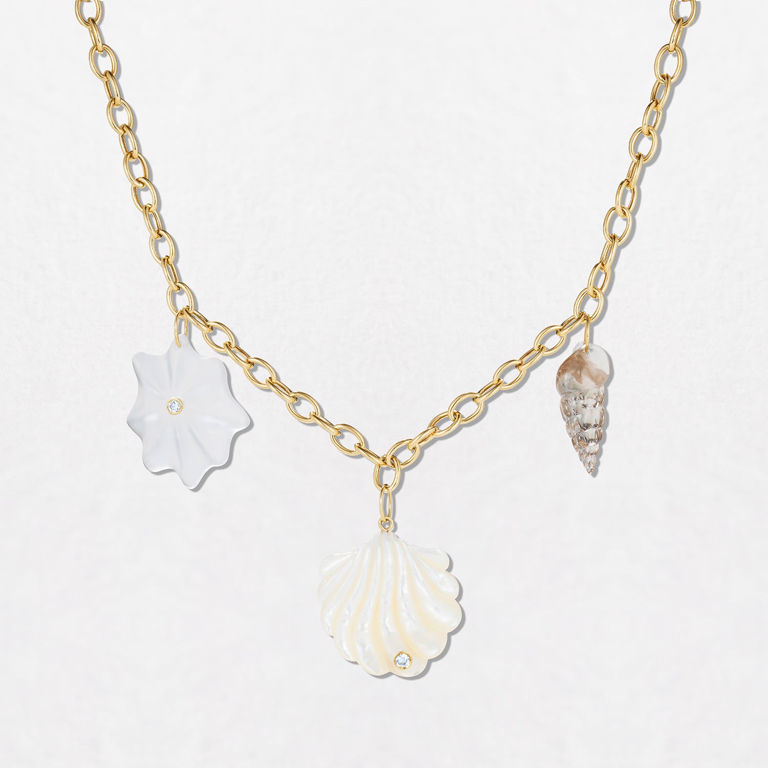 Handcrafted 18K yellow gold Shells Necklace featuring mother of pearl, quartz, smoky quartz, and diamond shell charms by Isabella Roux