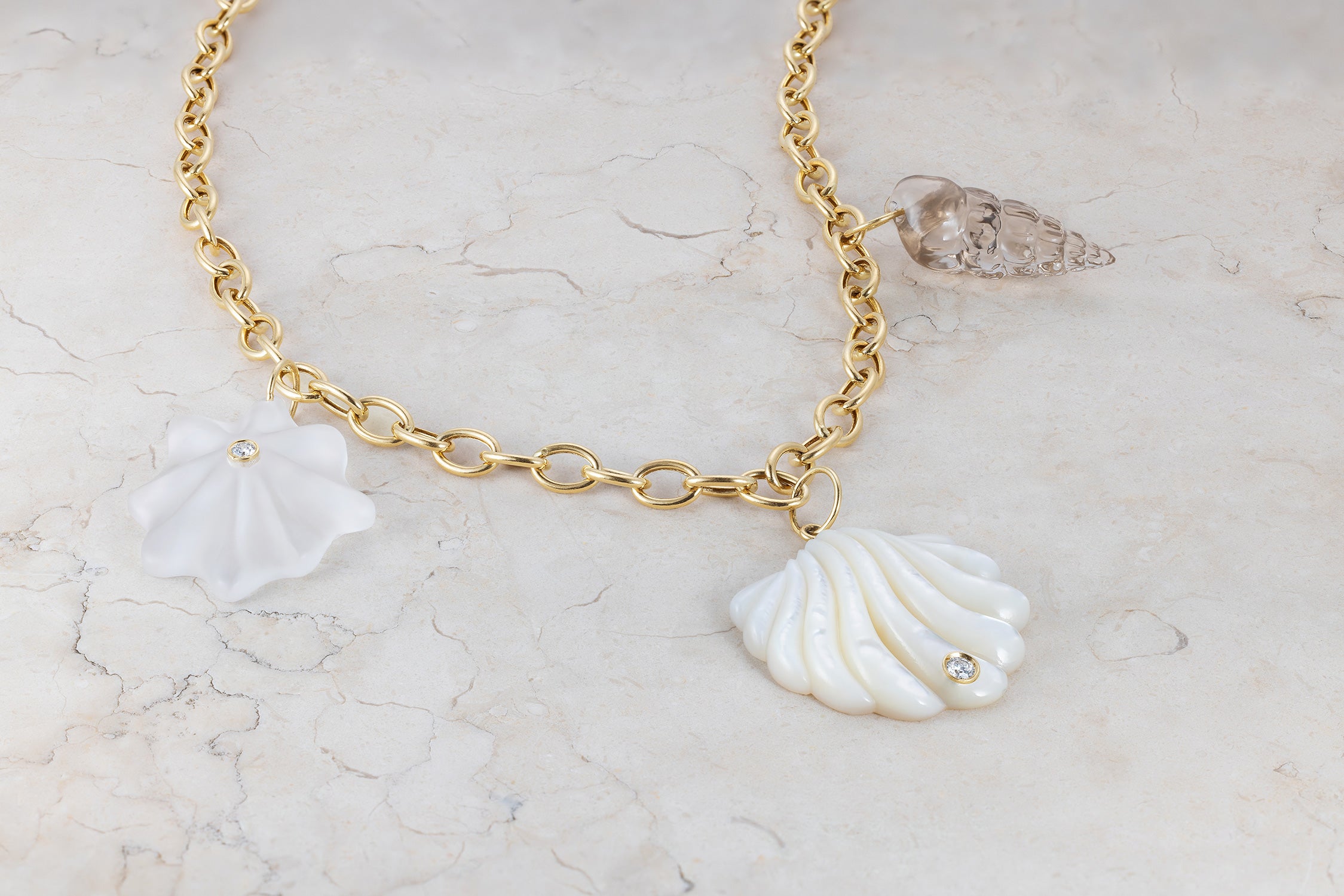 Handcrafted 18K yellow gold Shells Necklace featuring mother of pearl, quartz, smoky quartz, and diamond shell charms by Isabella Roux