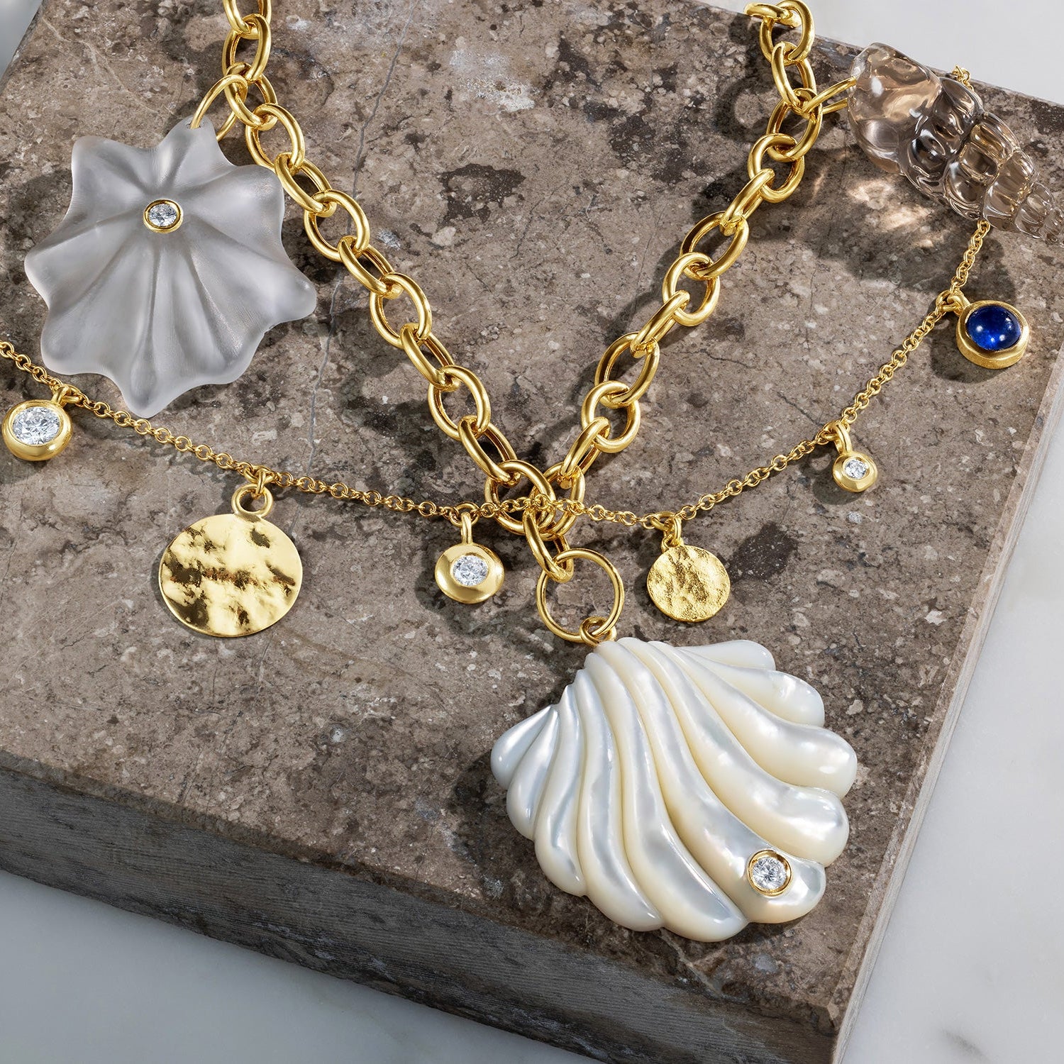 Handcrafted 18K yellow gold Shells Necklace featuring mother of pearl, quartz, smoky quartz, and diamond shell charms by Isabella Roux