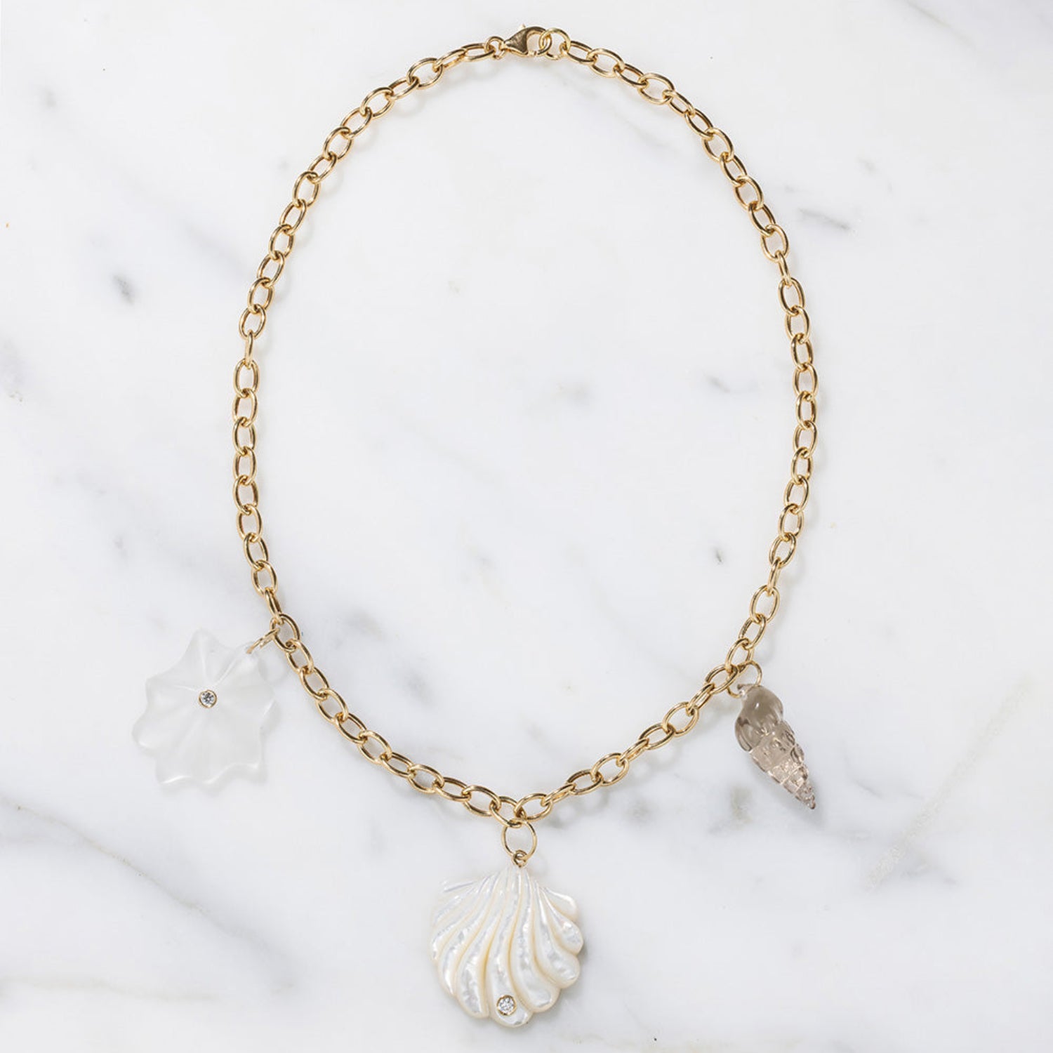 Handcrafted 18K yellow gold Shells Necklace featuring mother of pearl, quartz, smoky quartz, and diamond shell charms by Isabella Roux
