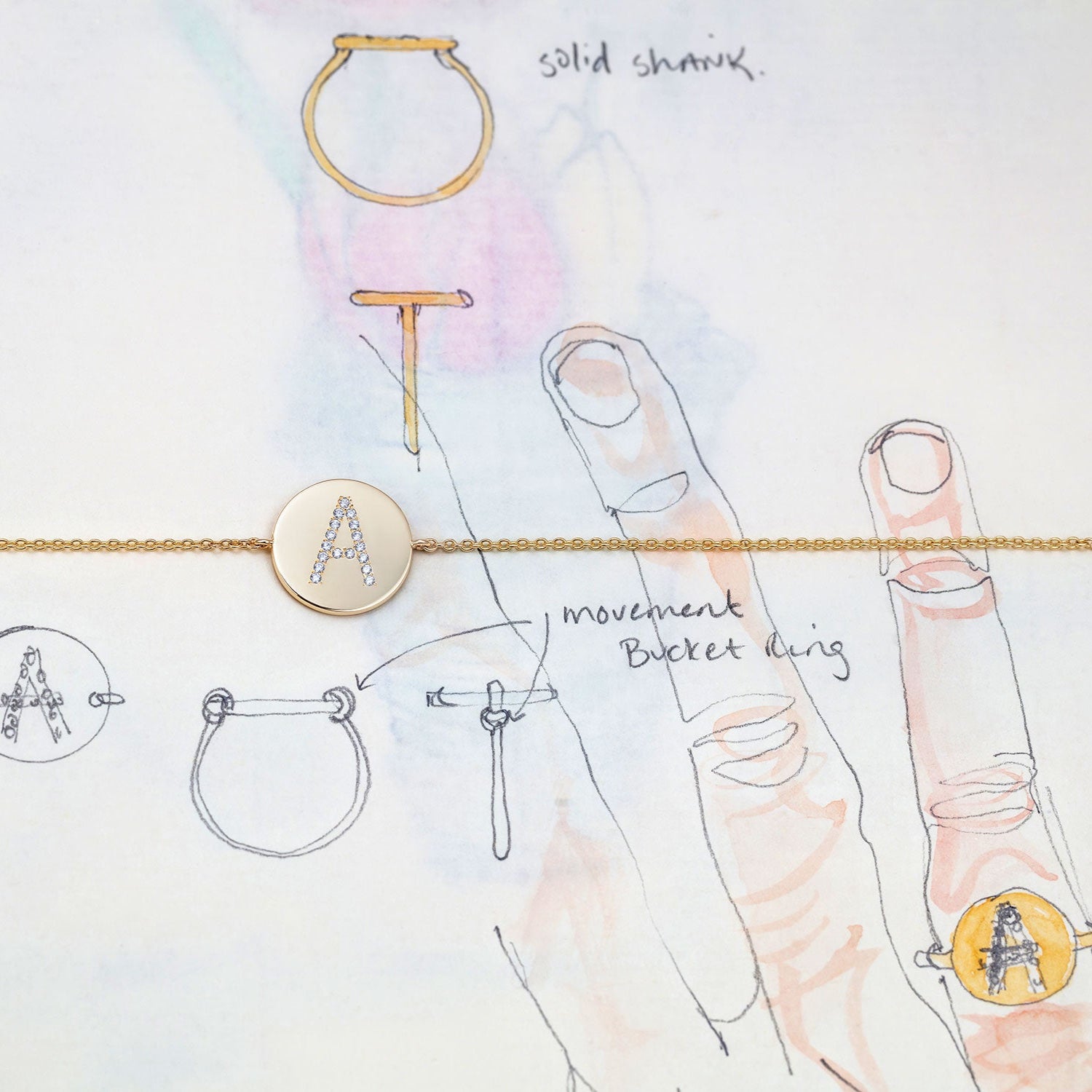 Jewellery illustration with bespoke 18K yellow gold Signature Alphabet Ring featuring custom lettering with white diamond accents by Isabella Roux.