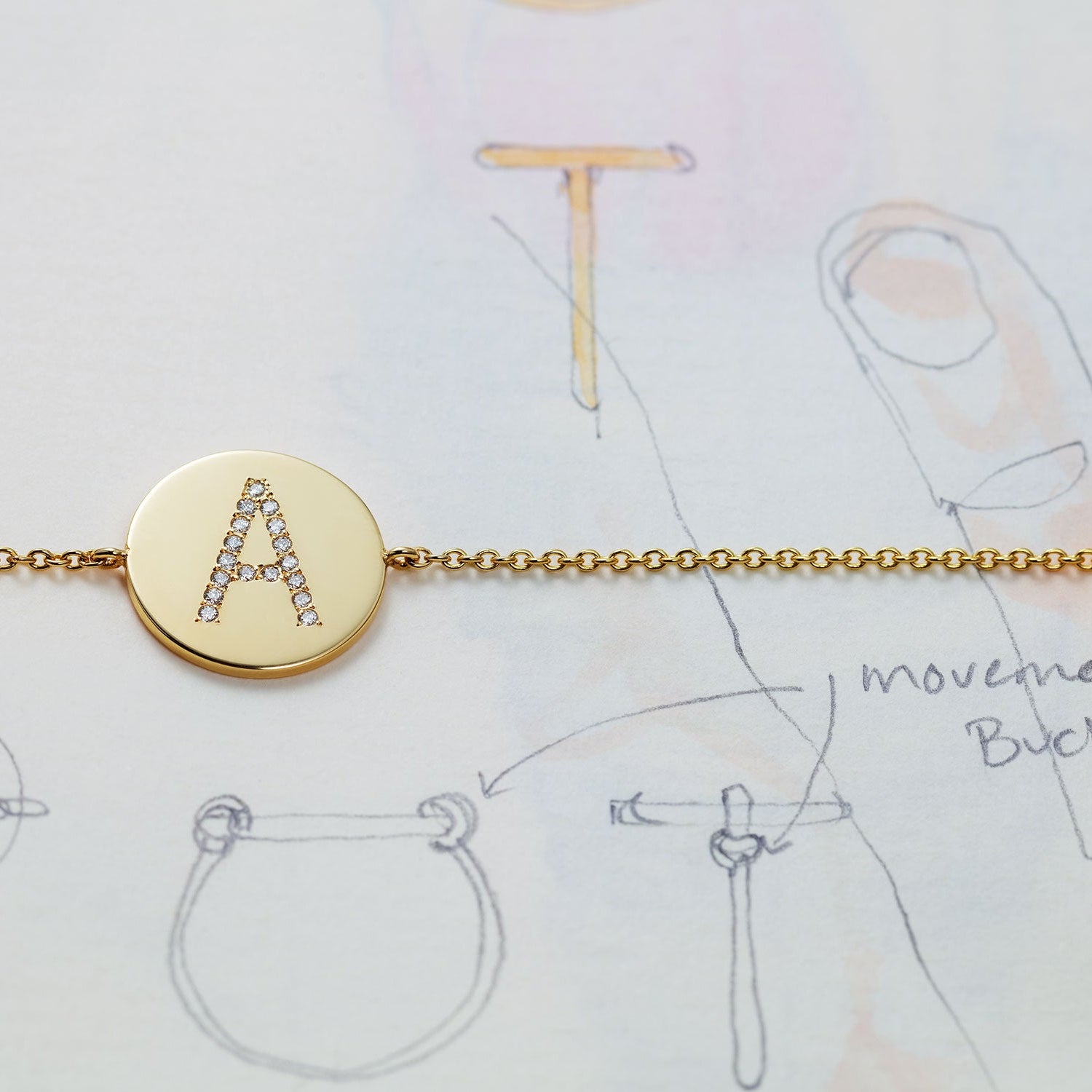 Bespoke 18K yellow gold Signature Alphabet Ring featuring custom lettering with white diamond accents by Isabella Roux