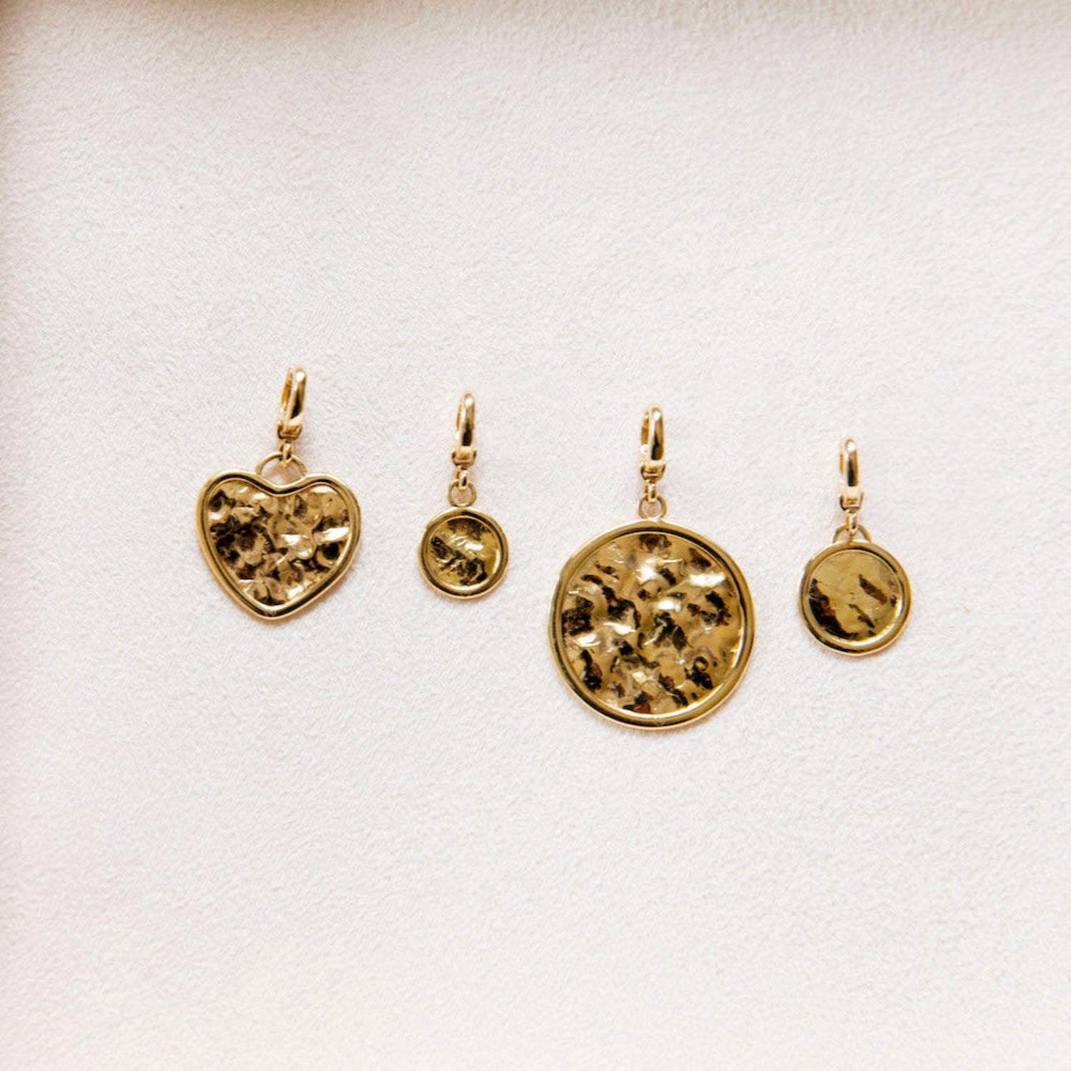 Hand-beaten 18K yellow gold Sun Disc Charm Pendant II featuring a 15mm textured gold disc with a smooth bezel and detachable clasp by Isabella Roux