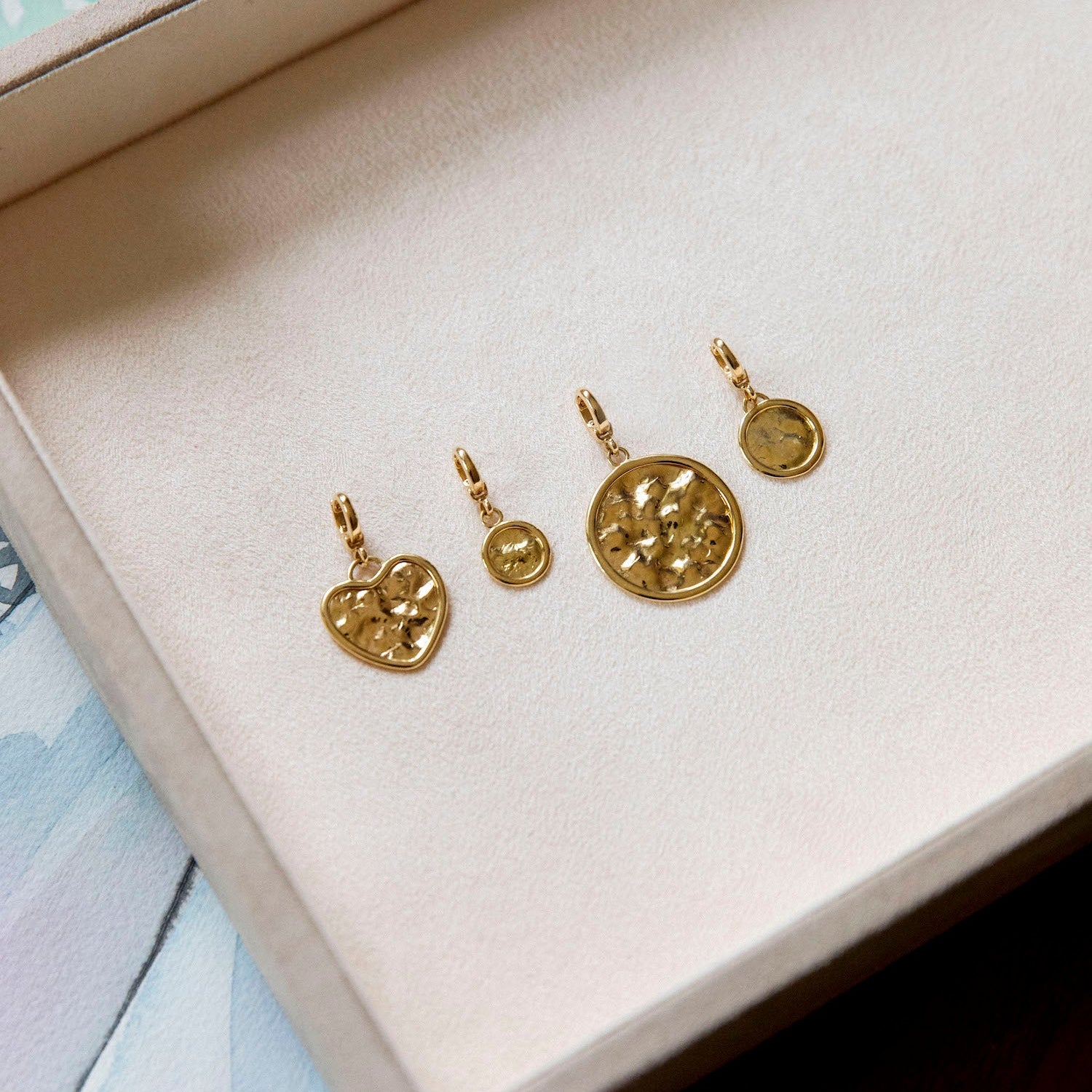 Hand-beaten 18K yellow gold Sun Disc Charm Pendant III featuring a 12mm textured gold disc with a smooth bezel and detachable clasp by Isabella Roux
