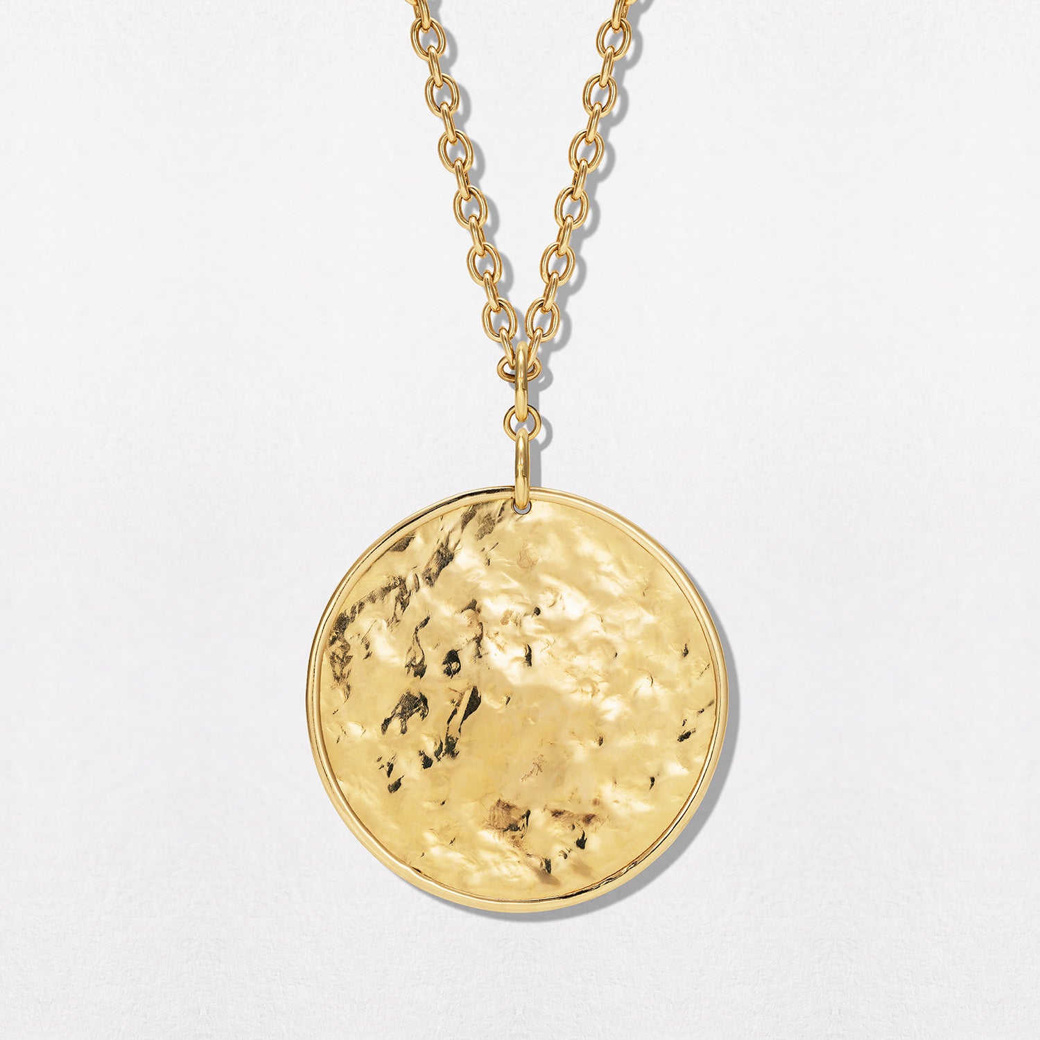 Hand-beaten 18K yellow gold Sun Disc Charm Pendant IV featuring a large 45mm textured gold disc with a smooth bezel and detachable clasp by Isabella Roux