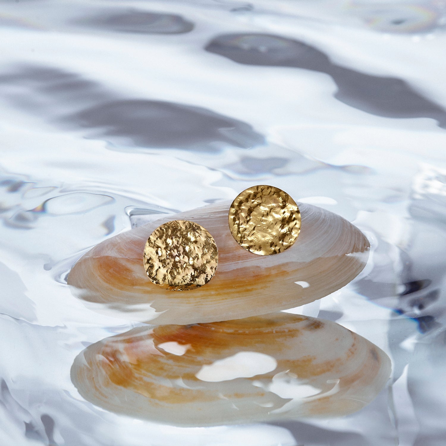 Hand-beaten 18K yellow gold Sun Disc Statement Earrings featuring 30mm textured gold discs for a beautiful finish by Isabella Roux