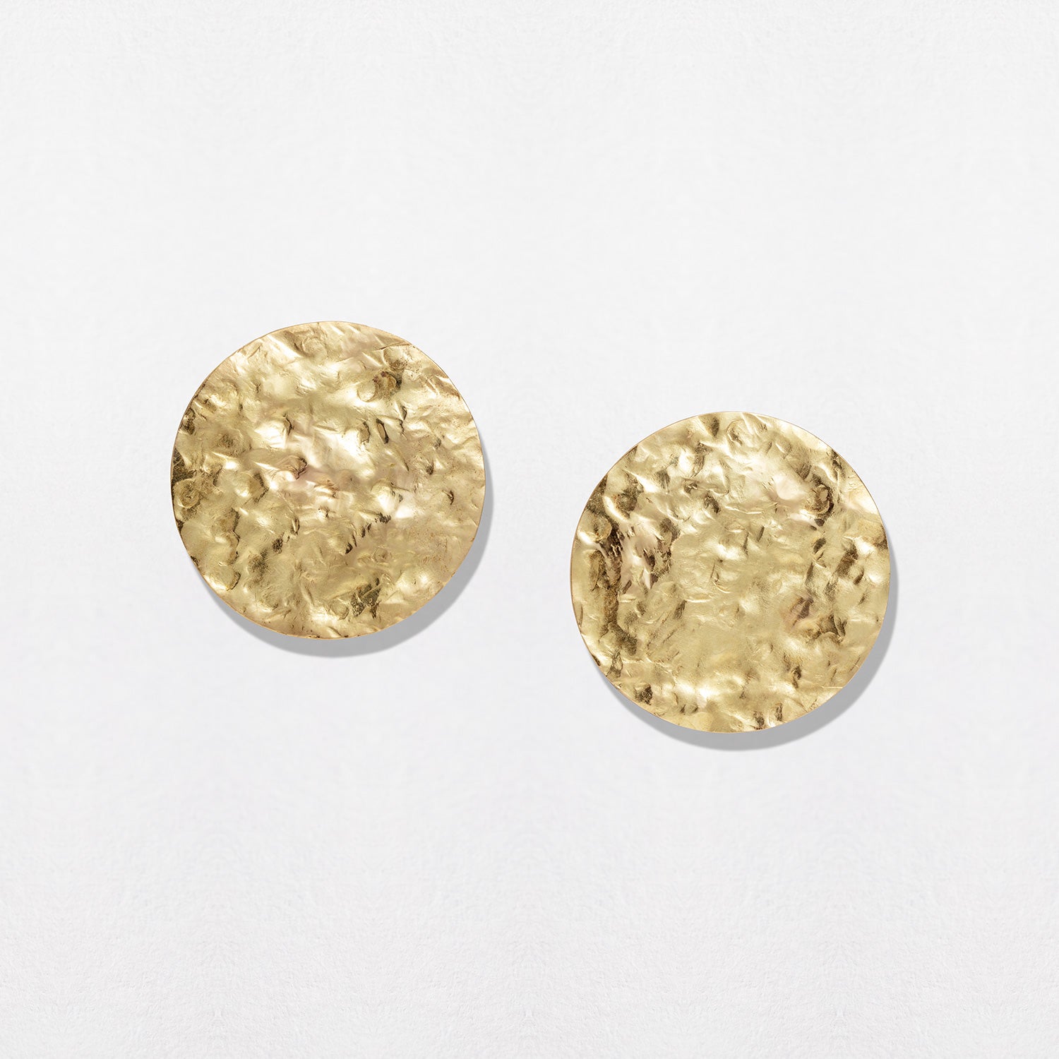 Hand-beaten 18K yellow gold Sun Disc Statement Earrings featuring 30mm textured gold discs for a beautiful finish by Isabella Roux